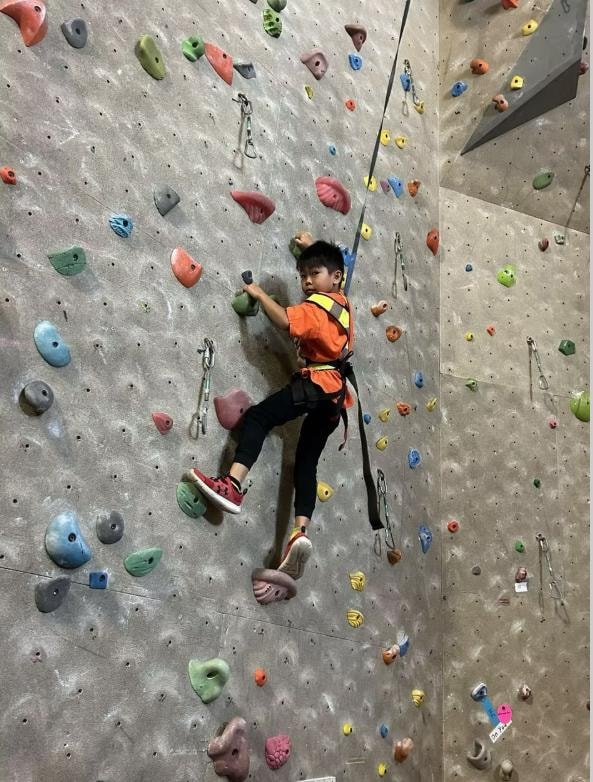 Child rock climbing at Kidspot Surrey enriched activities