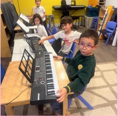 Children learning keyboard and music instruments at Kidspot Surrey